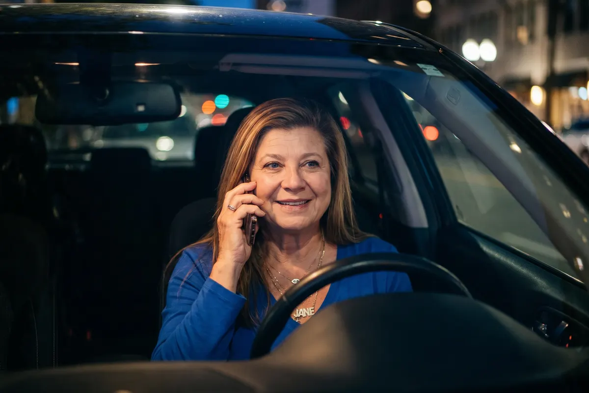 Jane Un on the phone in her car at night