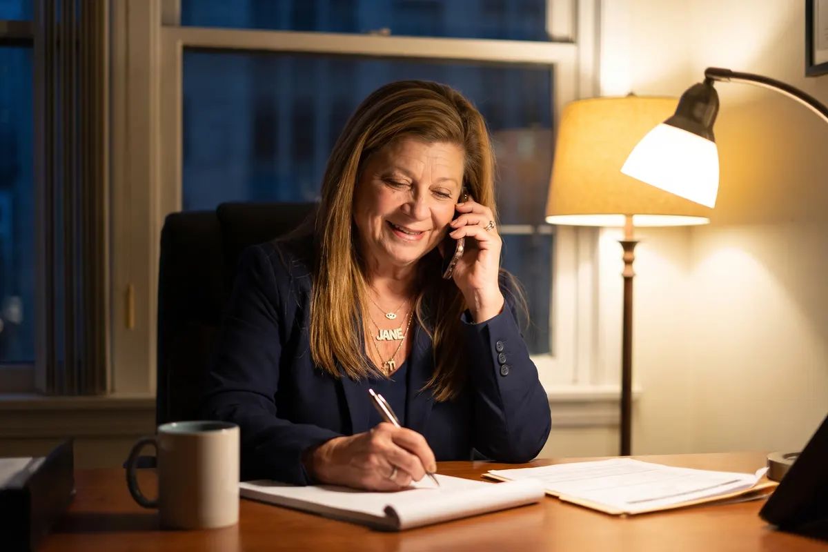 Jane Un taking a call at her desk late at night